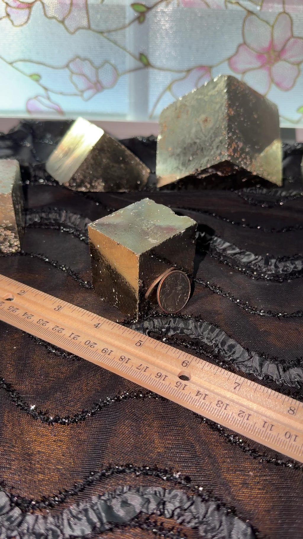 Bronze pyrite cube displayed next to ruler for size reference. Then held in hand and shown a 360 view.