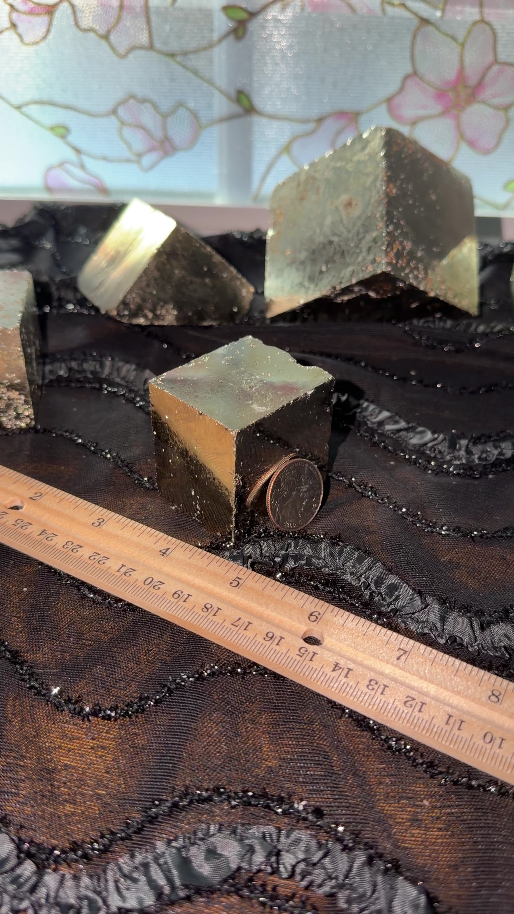 Bronze pyrite cube displayed next to ruler for size reference. Then held in hand and shown a 360 view.