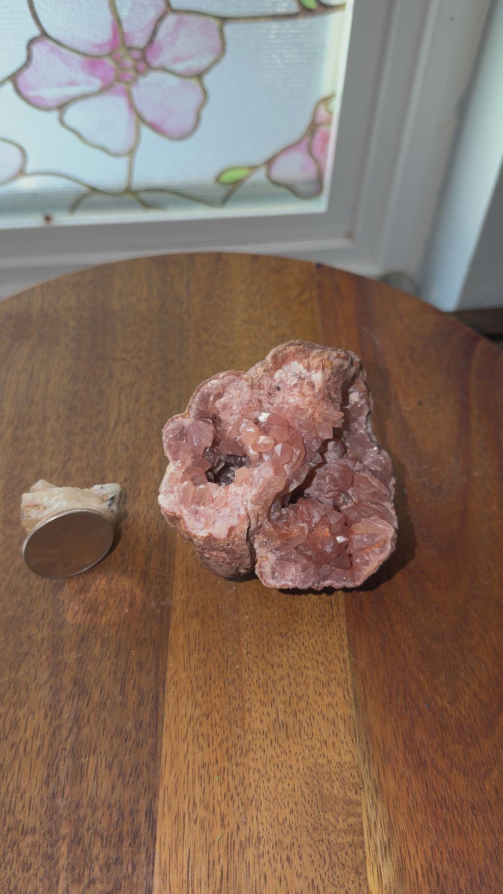 Natural deeply saturated pink amethyst geode shown next to quarter for size reference. Displayed on spinning table and shown a 360 view. 