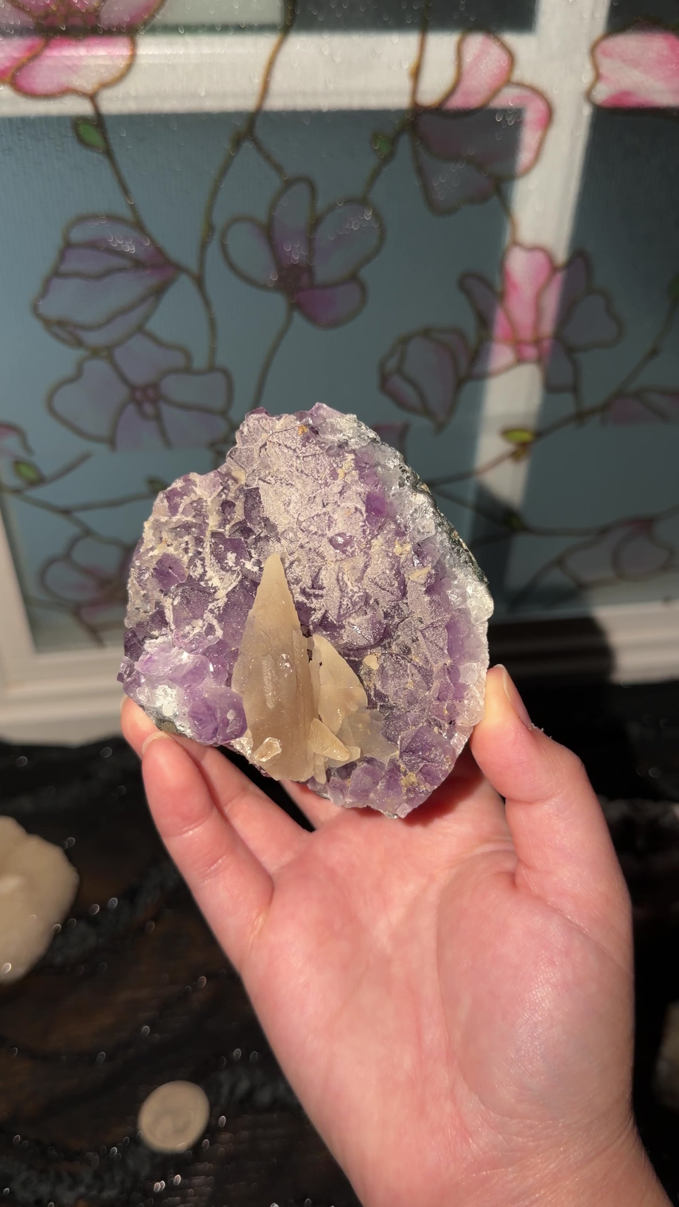 Yellow dogtooth calcite cluster formed on a purple amethyst point cluster. 