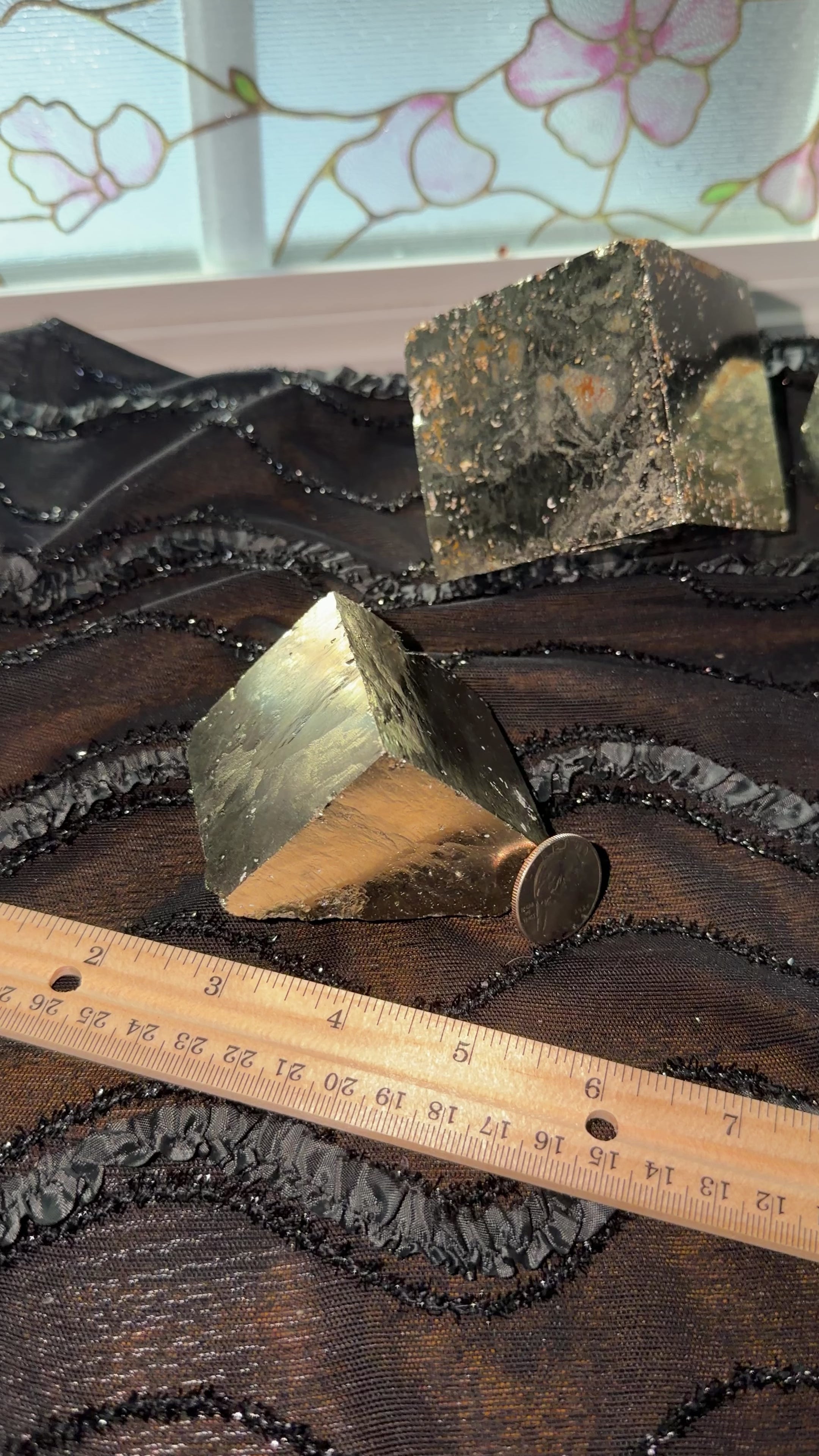 Bronze pyrite cube corner displayed next to ruler for size reference. Then held in hand and shown a 360 view.