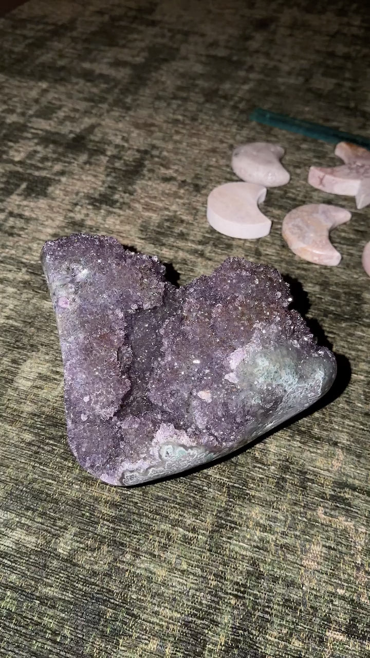 Extra large gemmy Brazilian amethyst rosette cluster with mossy agate banding and gold geothite inclusions. Internal caves.