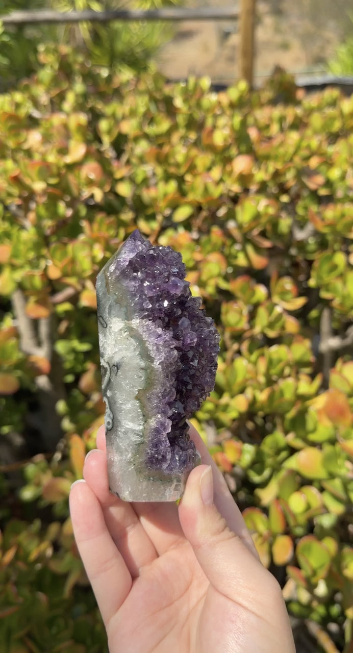 Close up highlighting the dark purple points and green moss agate. 