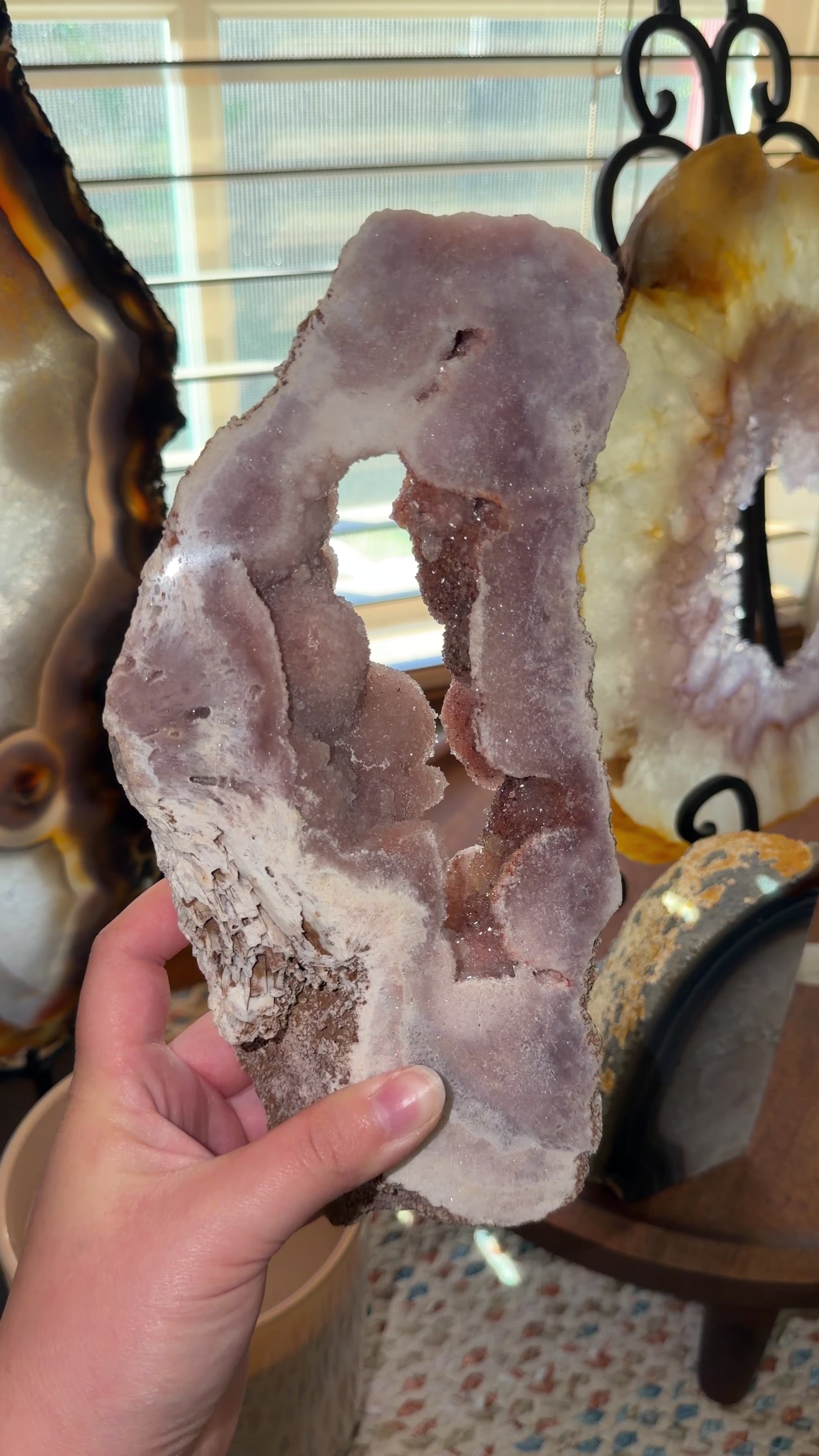 Close up of Brazilian pink amethyst portal highlighting the druzy red inner formations.
