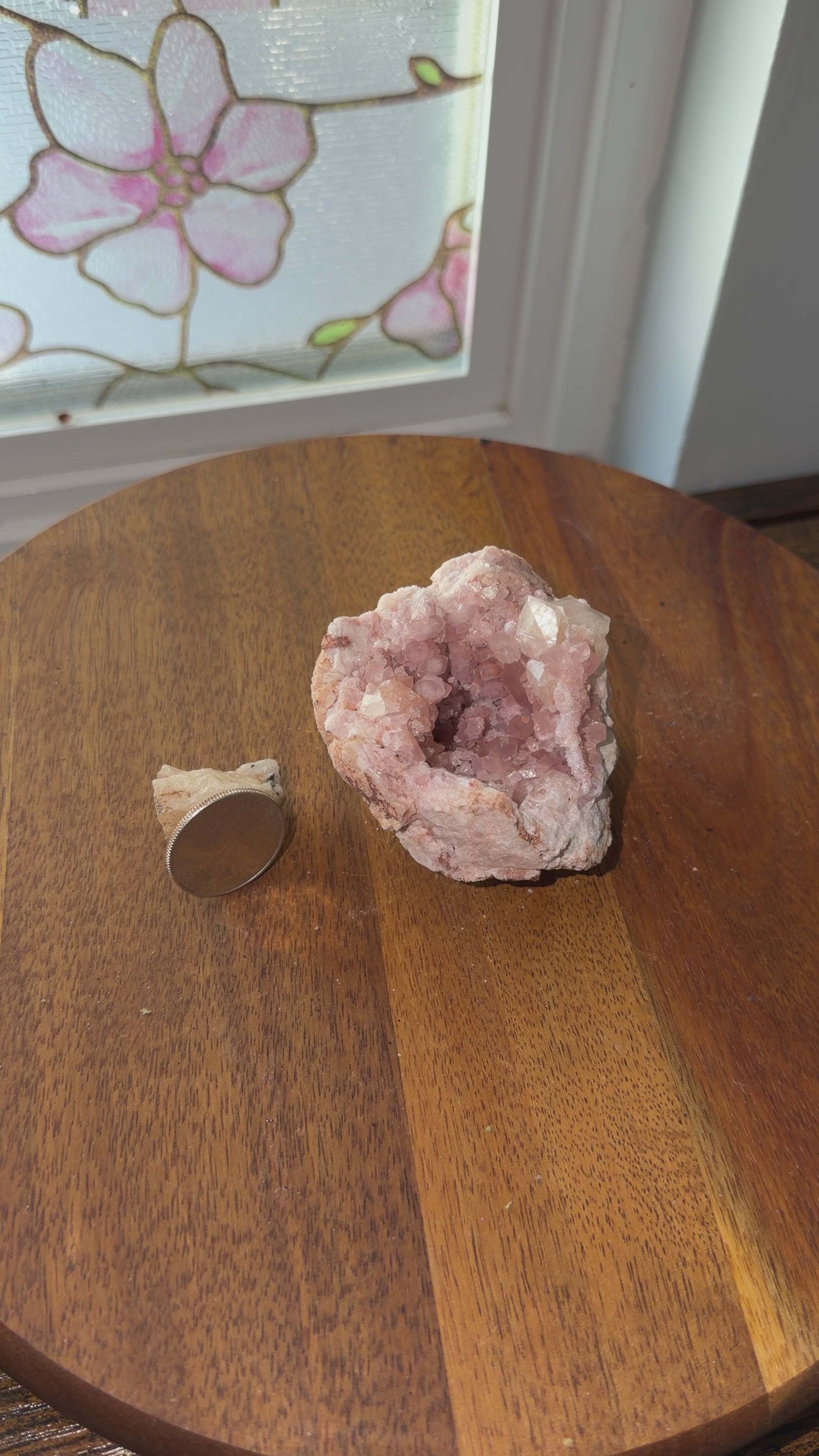 Pink amethyst geode shown next to a quarter for size reference on a spin table giving a 360 view. 