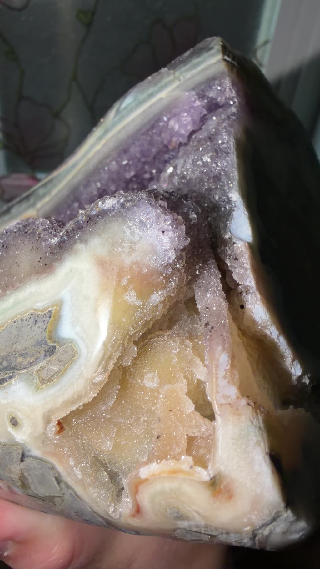 Close up highlighting the druzy orange quartz bridges, purple points, and hidden portal cave.