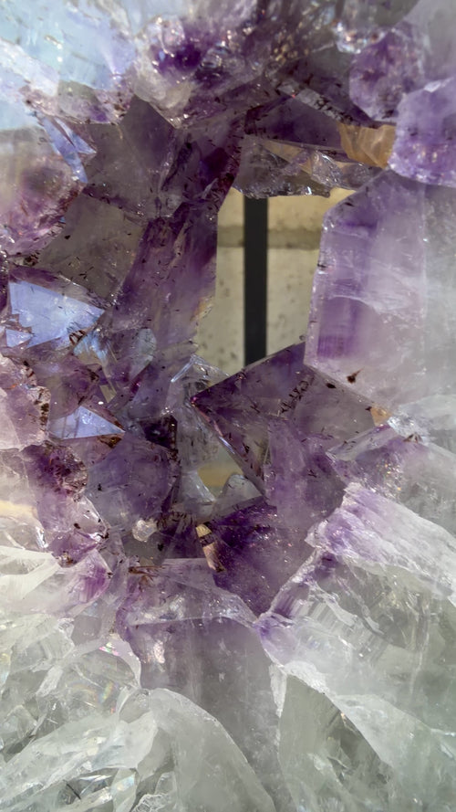 Close up highlighting the purple points and gold geothite inclusions. 