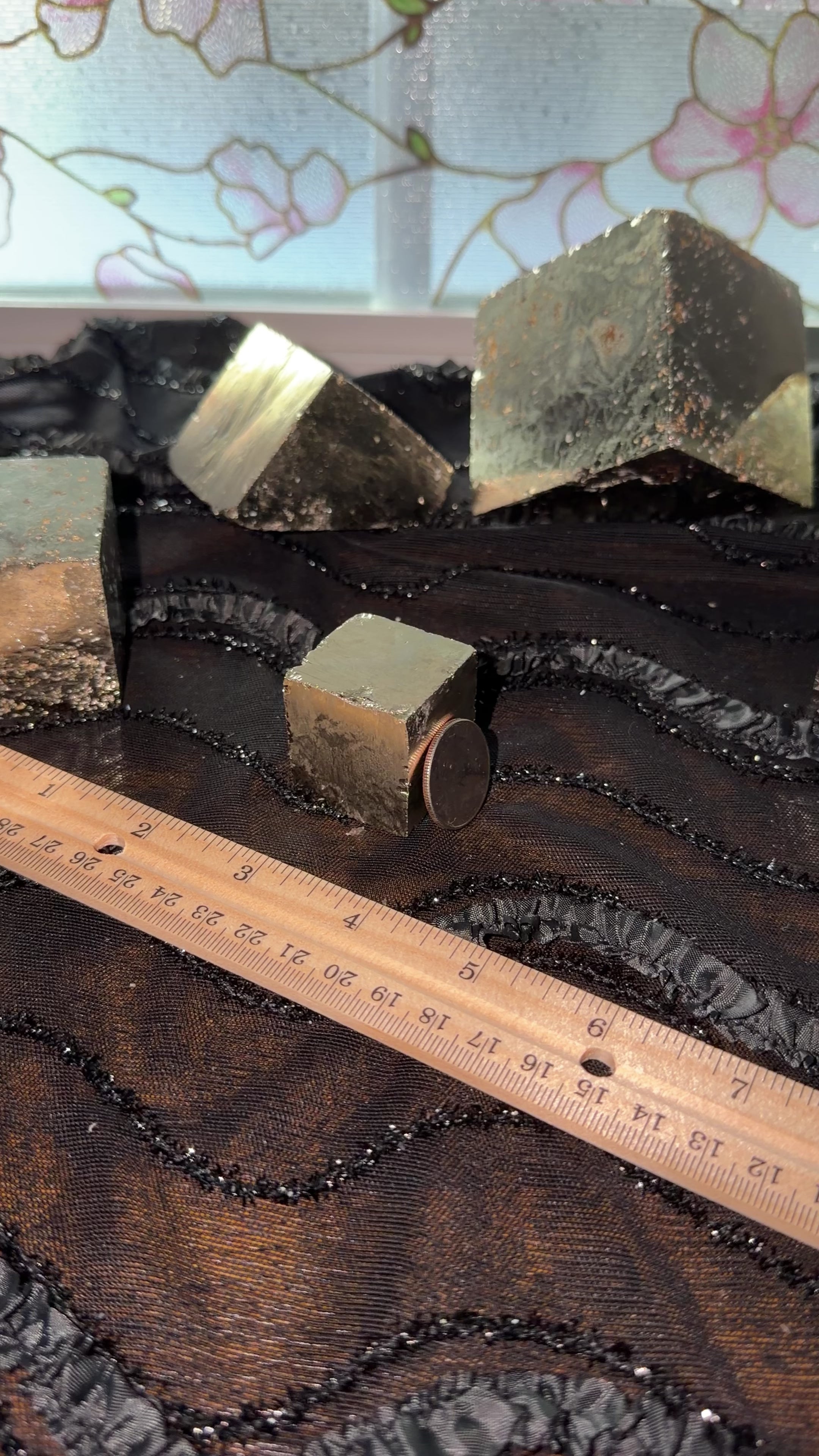 Bronze pyrite cube displayed next to ruler for size reference. Then held in hand and shown a 360 view.